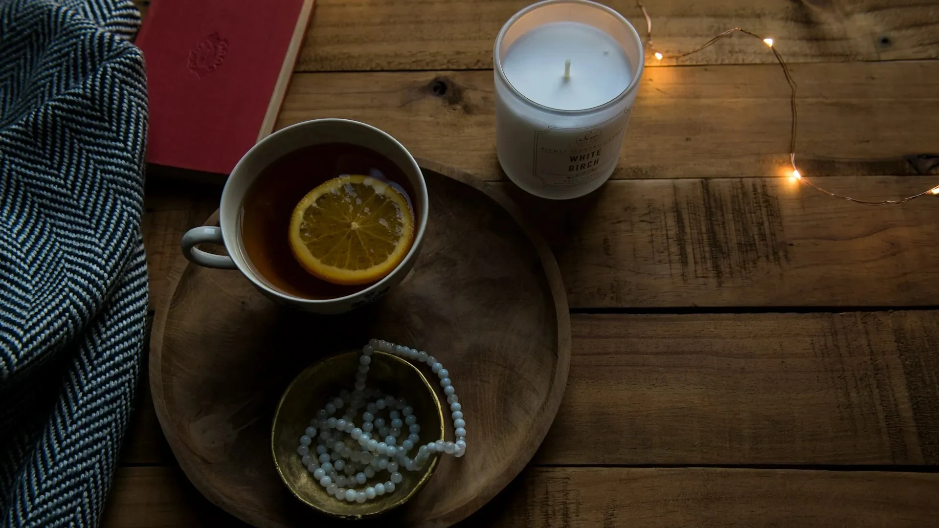 Burnout & nutrition still life with lemon tea, candle, and cozy textures—symbolizing nutrition, rest, and stress-relief for mental exhaustion.